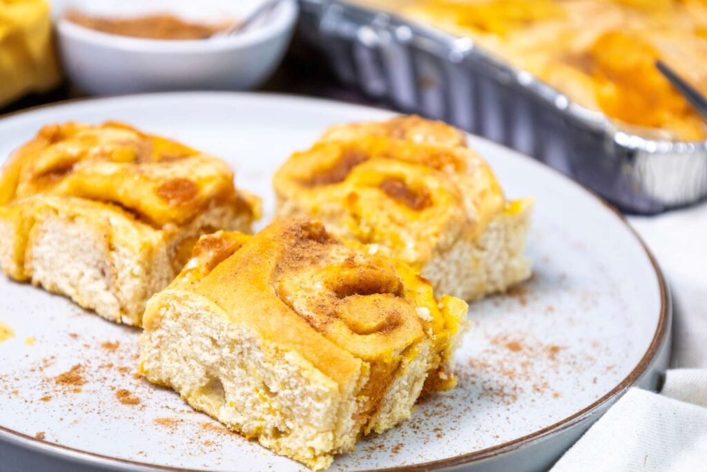 Pour the mixture evenly over the freshly baked rolls and let it set for 5-10 minutes. Serve with a sprinkle of cinnamon on top.